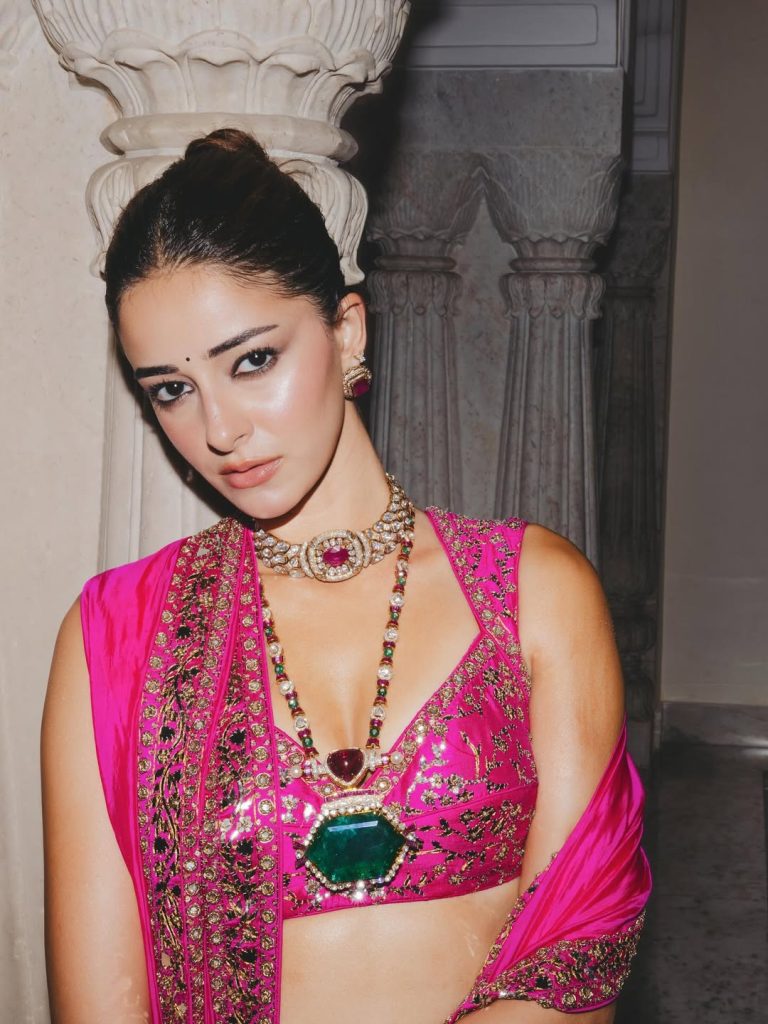 Ananya Panday walking the ramp in a fuchsia pink lehenga