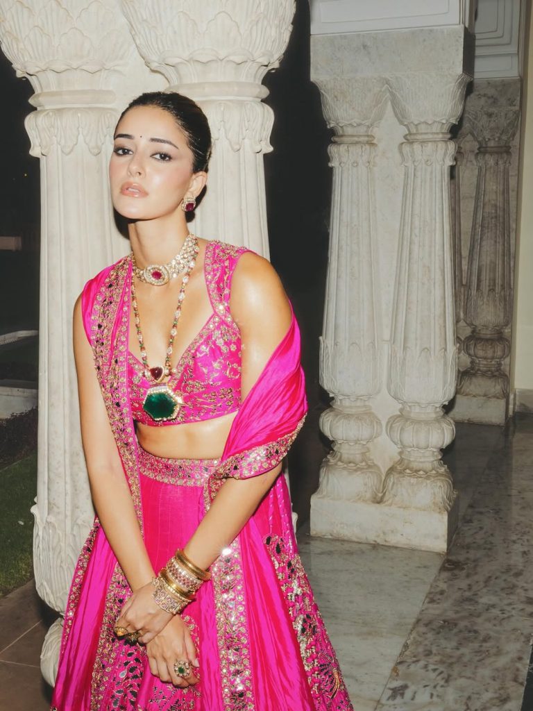 Ananya Panday walking the ramp in a fuchsia pink lehenga